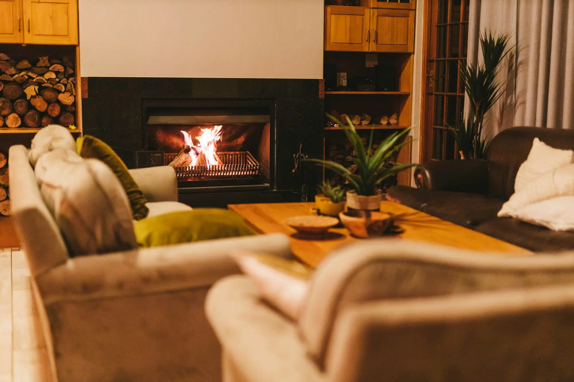 A fire burning in a built-in fireplace in a cozy living room