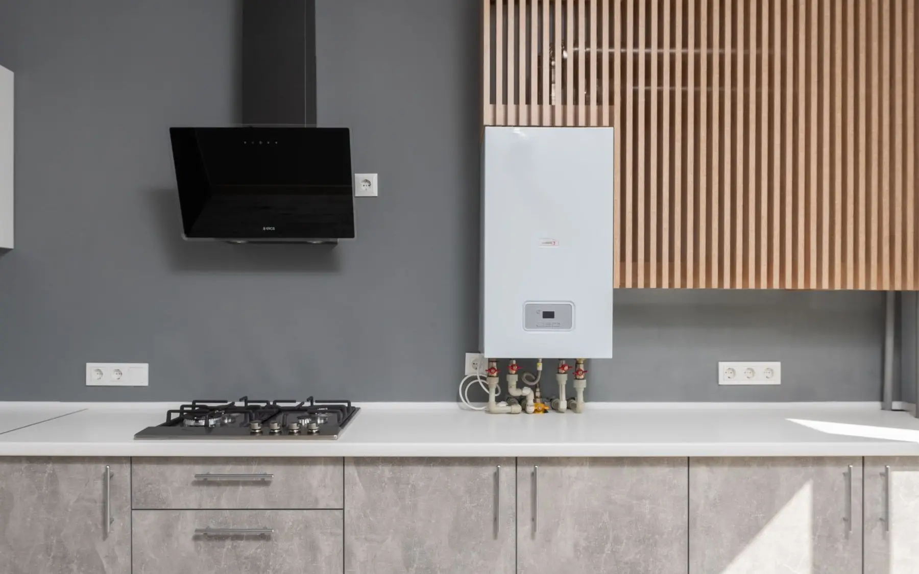 A wall-mounted tankless water heater above a kitchen counter